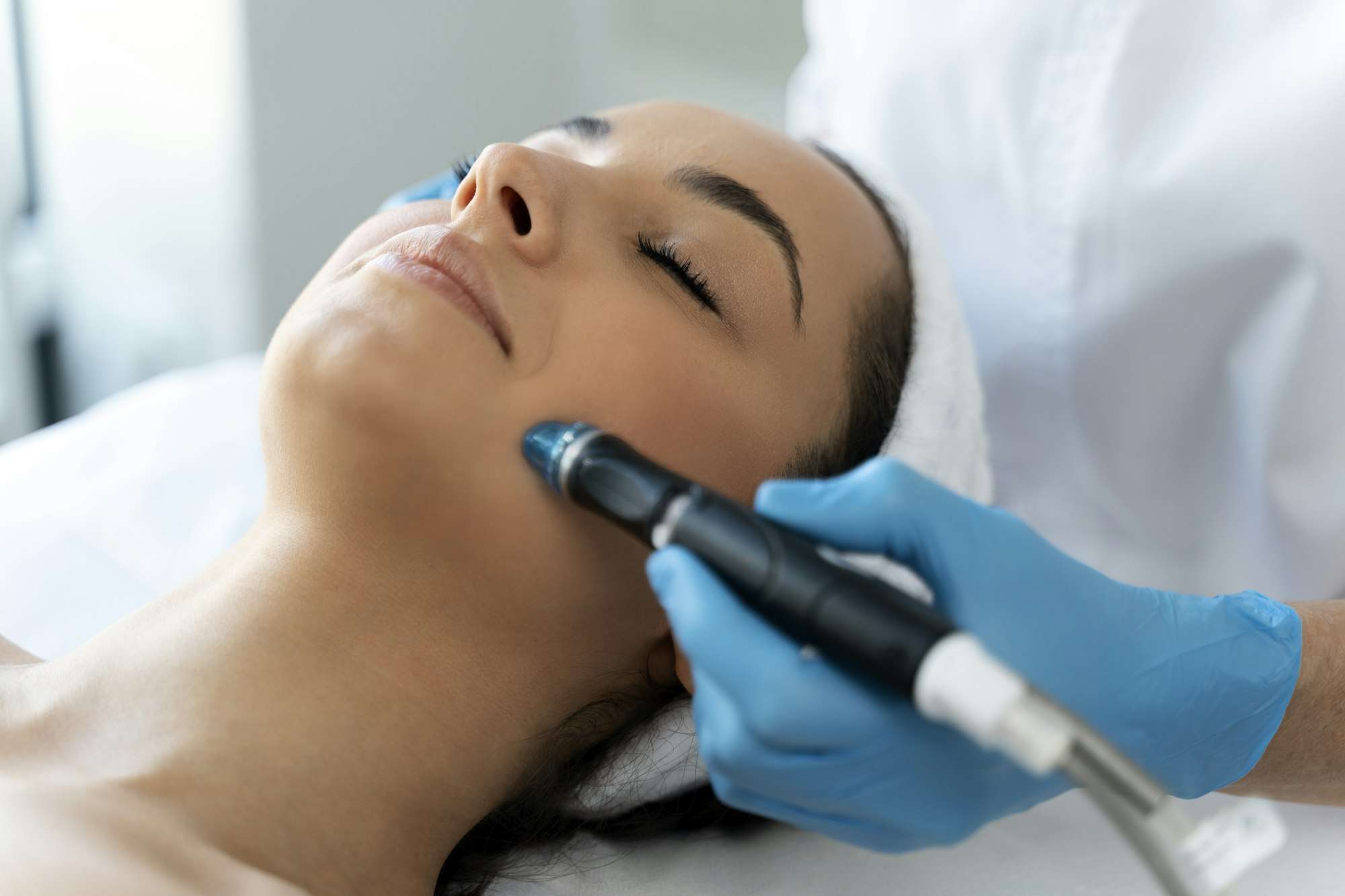 Close-up of woman getting facial hydro microdermabrasion peeling treatment